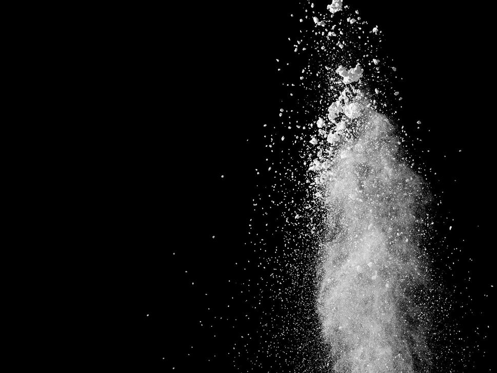 White powder splatter on black background